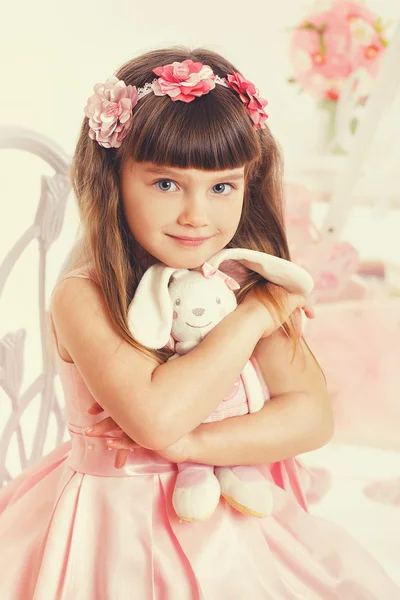 Portrait of Beautiful young girl with toy in her hands — Stock Photo, Image