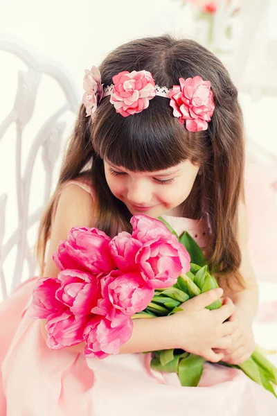 Portrait of a beautiful little girl with flowers — Stock Photo, Image