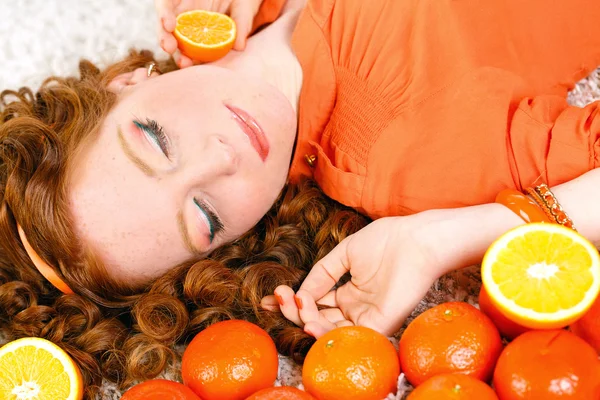 Retrato de mulher sorridente caucasiano atraente isolado no estúdio branco tiro com laranjas — Fotografia de Stock