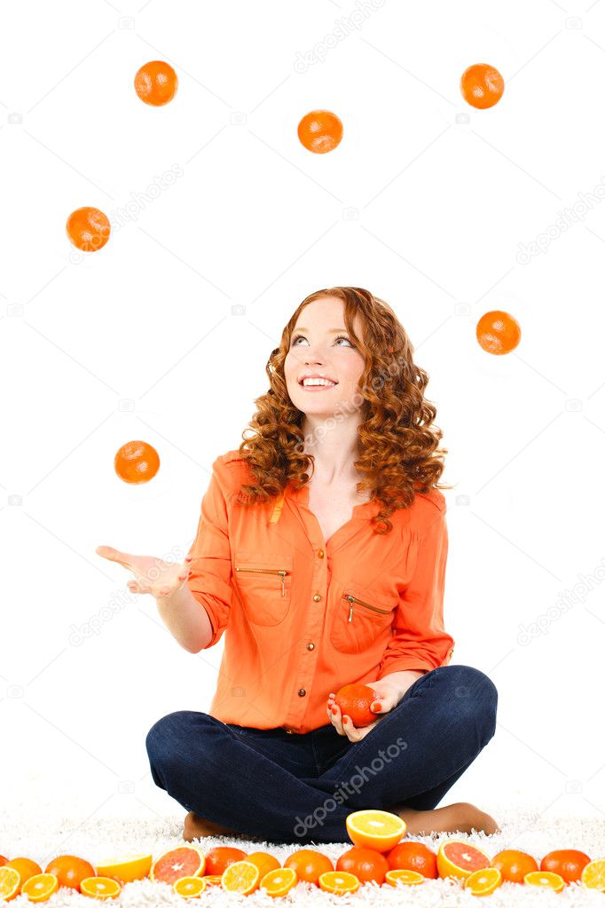 Portrait of attractive caucasian smiling woman isolated on white studio shot with oranges