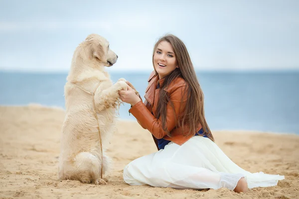 Kumsalda köpeği olan kız. — Stok fotoğraf