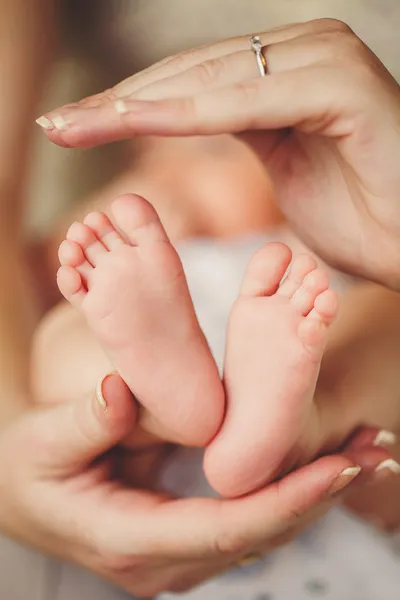 Des jambes de bébé. Jambes nouveau-né dans la main des parents. Pieds infantiles . — Photo