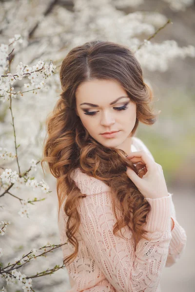 Retrato de la joven morena en el jardín floreciente de primavera —  Fotos de Stock