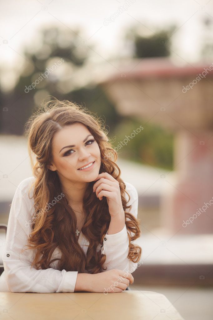 Portrait of young brunette in the spring blooming garden
