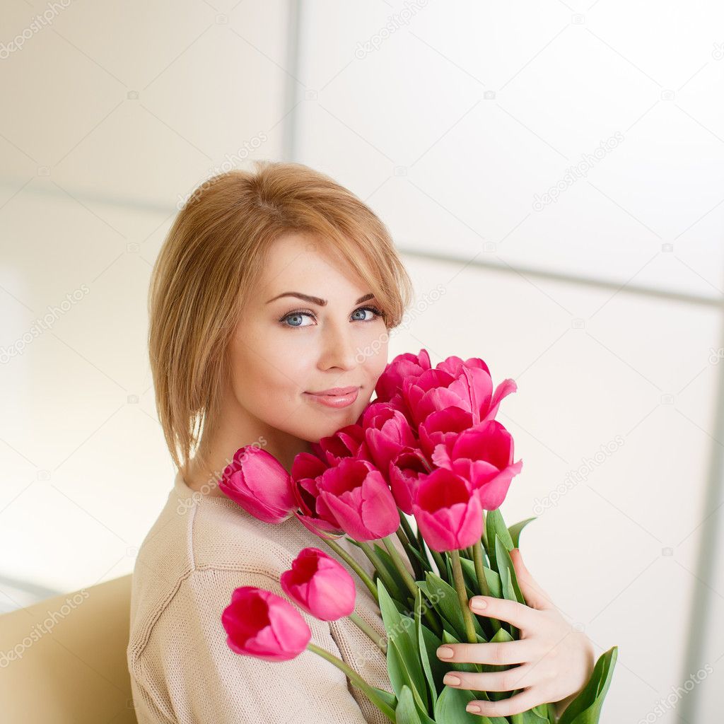 Bright pink flowers in girl's hands.