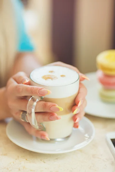 A hot Cup of coffee latte with colorful sculpture cookies — Stock Photo, Image