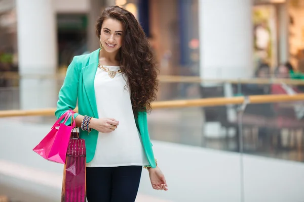 Beautiful young woman with shopping bags and gifts. — Stock Photo, Image