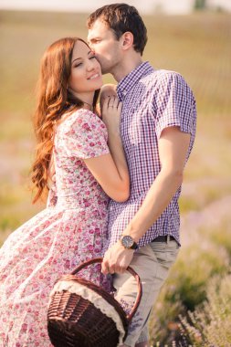 Young couple in love outdoor.Stunning sensual outdoor portrait of young stylish fashion couple posing in summer in field clipart