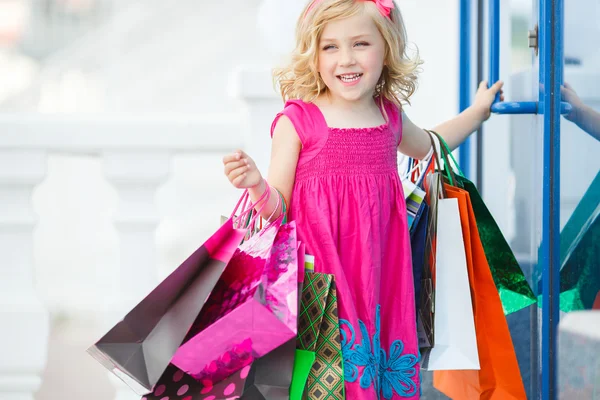 Fun preschool girl walking with bags. — Stock Photo, Image