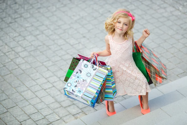 Fun preschool girl walking with bags. — Stock Photo, Image