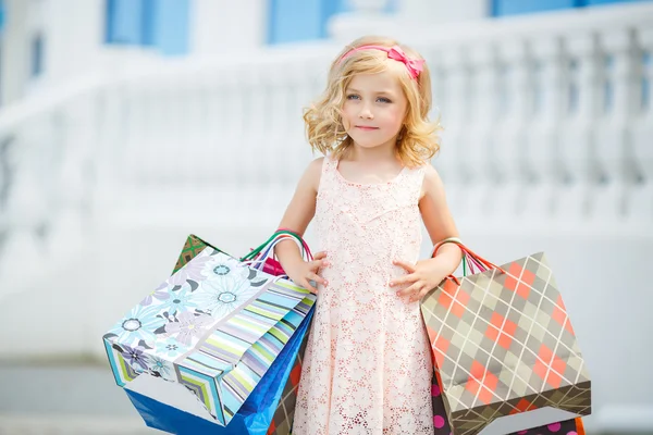 Little girl fashion with packages at the Mall. — Stock Photo, Image