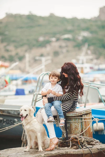 Mother and son on the waterfront with a dog — Stock Photo, Image