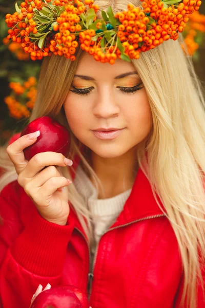 Girl in Orange wreath with Red Apple in hand — Stock Photo, Image