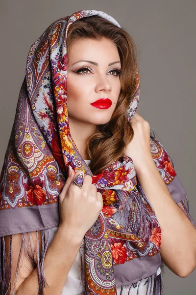 Portrait of a beautiful young woman with a scarf on her head — Stock Photo, Image