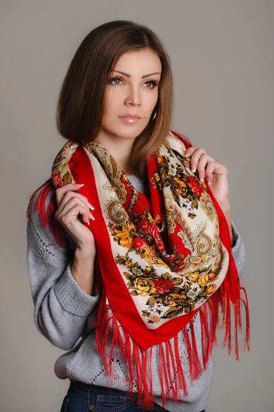 Portrait of a beautiful young woman with a scarf. — Stock Photo, Image