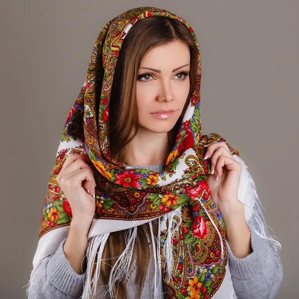 Portrait of a beautiful young woman with a scarf on her head — Stock Photo, Image