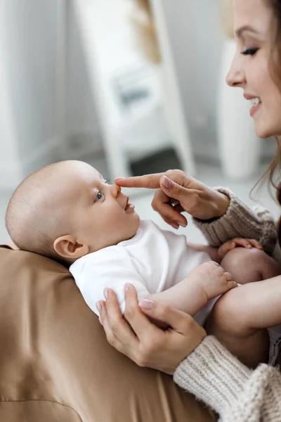 Mother and lovely baby and daughter indoor at home — стоковое фото