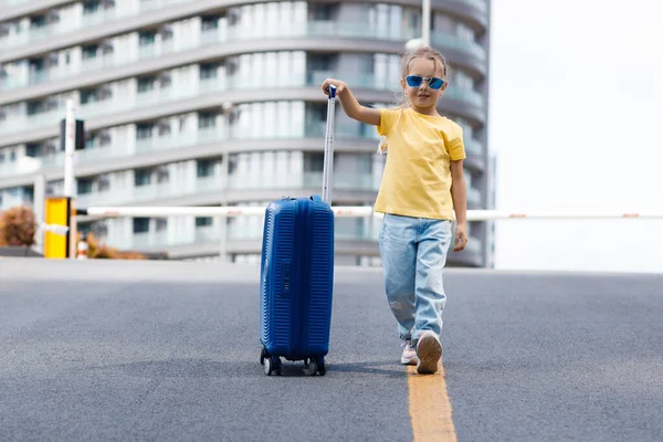 Cute child with suitcase outdoor — Stok fotoğraf
