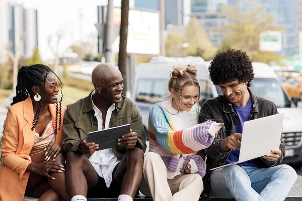 group of people with laptop studying and having fun outdoor. High quality photo