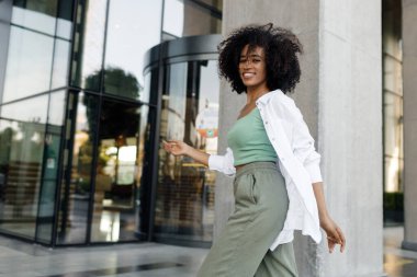 dancing smiling afro woman outdoors. High quality photo