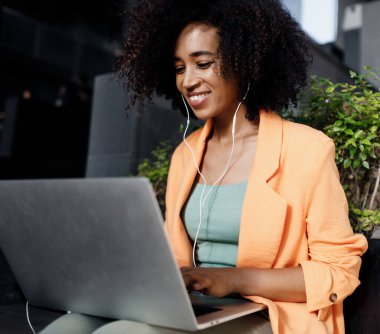 afro woman using laptop outdoor. High-quality photo