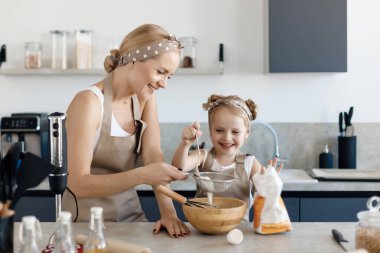 mother and daughter cooking and baking in the kitchen. High-quality photo