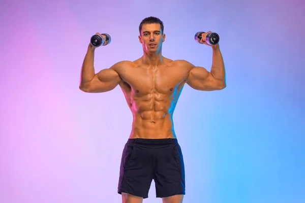 Man athlete with dumbbell on pink background. Gym full body workout. Muscular man athlete in fitness gym have havy workout. Sports trainer on trainging. Fitness motivation. — Stock Photo, Image