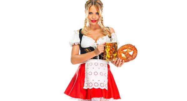 Young sexy Oktoberfest girl waitress, wearing a traditional Bavarian or german dirndl, serving big beer mugs with drink isolated on white background