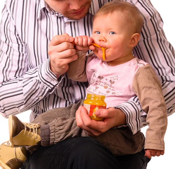 Man is feeding his baby — Stock Photo, Image