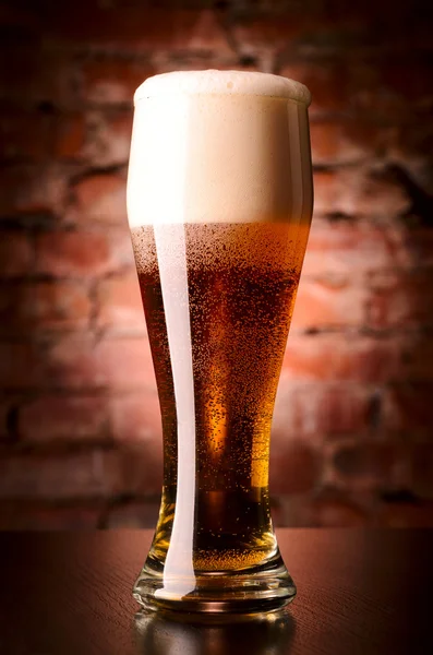 Glass of lager on table — Stock Photo, Image