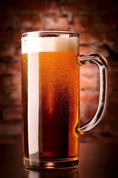 Glass of lager on table — Stock Photo, Image