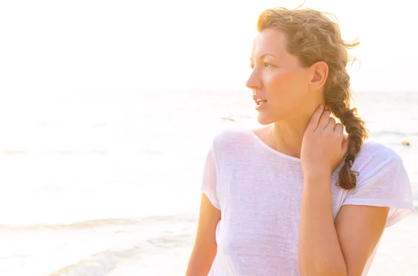 Frau am Strand bei Sonnenaufgang — Stockfoto