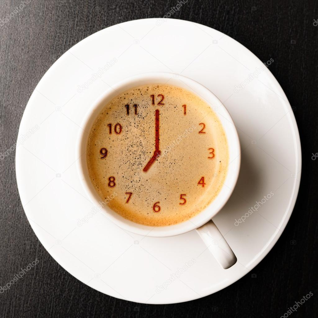 Clock on cup of fresh espresso