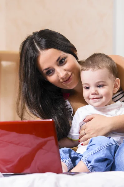 Mother and son are using laptop — Stock Photo, Image