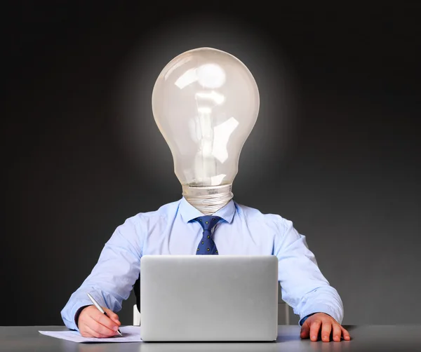 Businessman with bulb instead of his head — Stock Photo, Image