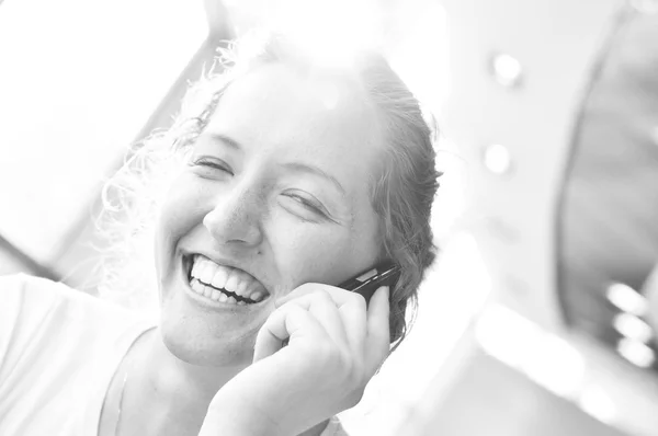 Woman is talking phone in sunny cafe — Stock Photo, Image