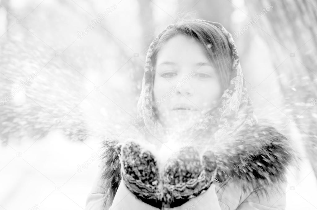 woman is blowing snow