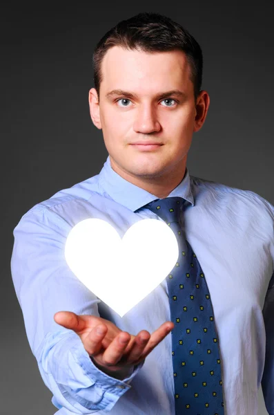 Businessman is holding heart — Stock Photo, Image