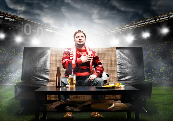 Soccer fan on sofa — Stock Photo, Image