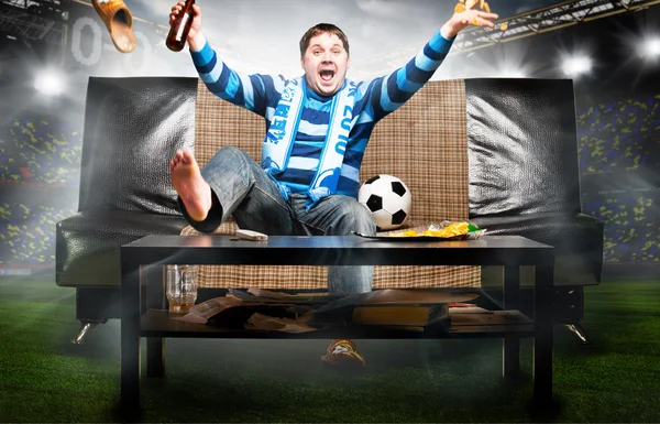 Soccer fan on sofa — Stock Photo, Image