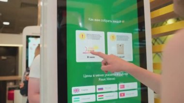 SAINT-PETERSBURG, RUSSIA - JUNE 29, 2022: woman ordering food at fast food restaurant Vkusno I Tochka, which are reopened clones of McDonalds who left Russia after sanctions were imposed.