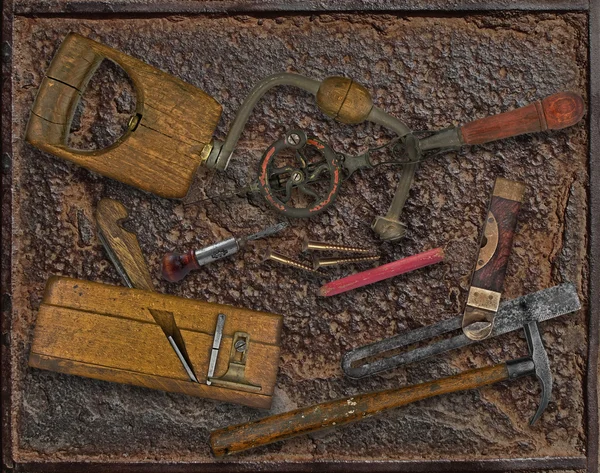 Vintage woodworking tools over rusty plate — Stock Photo, Image
