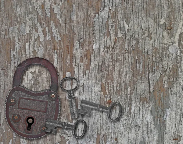 Vintage padlock on a old wooden panel — Stock Photo, Image