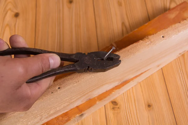 Pliers and nail — Stock Photo, Image