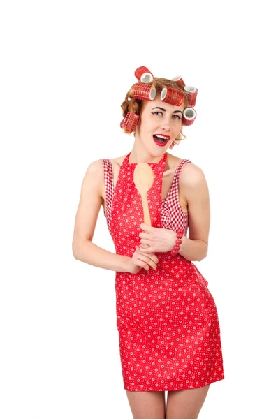 Meisje in een rode jurk met houten lepel — Stockfoto