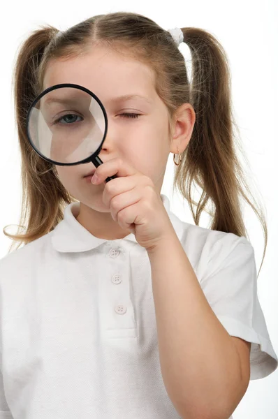 Little girl looking through a magnifying glass — Stock Photo, Image