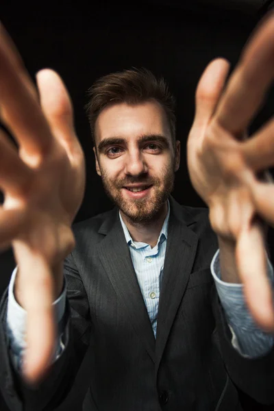 Young businessman on a dark background Royalty Free Stock Images