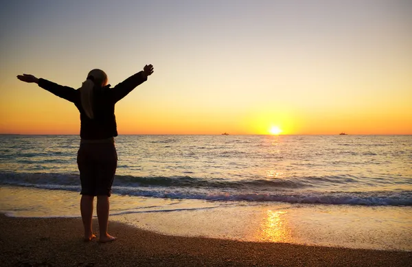 Female silhouette on seacoast Stock Picture