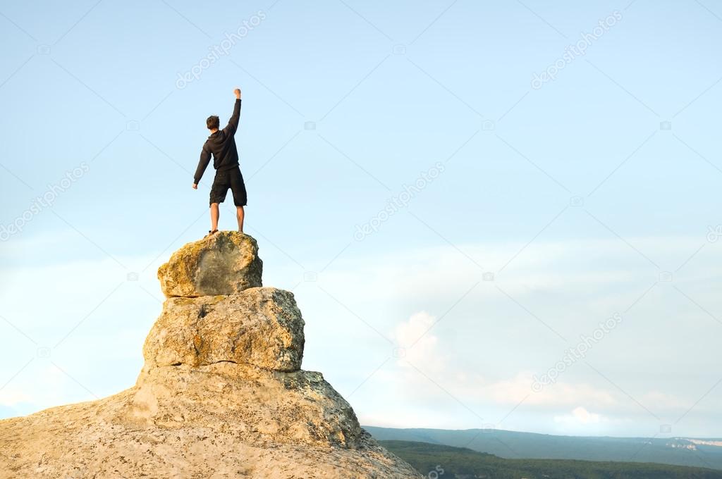 Man on top of mountain.