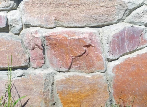 Masonry surface. Stone wall texture. Red natural stone wall texture.